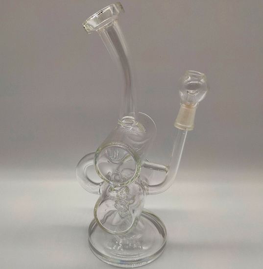 Clear glass beaker bong with stacked percolator chamber and female joint grommet on light gray background
