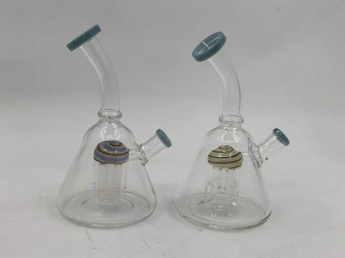 Two clear glass bongs with striped spiral dome percolators and teal silicone caps on white