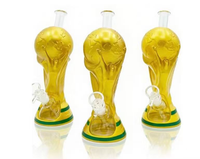 Three amber trophy-shaped novelty glass bongs with green base bands displayed on a white studio background