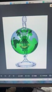 Globe shaped glass bong with green continents blue oceans on photo viewer