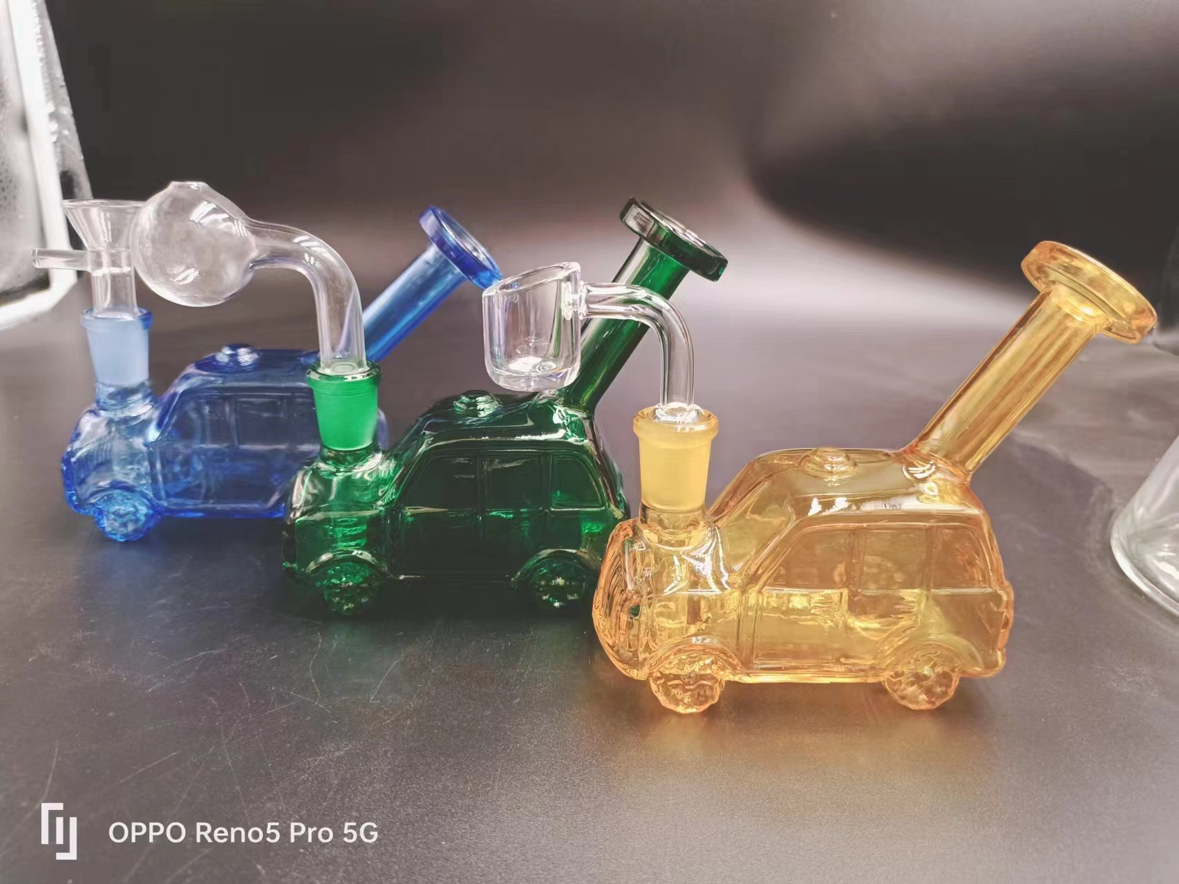 Custom-branded wholesale steamroller pipes with logo etching and color options on a factory display rack