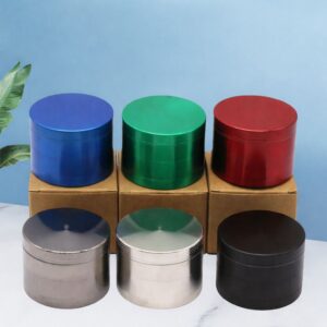 Colorful metal herb grinders in six finishes displayed on marble surface for wholesale supply