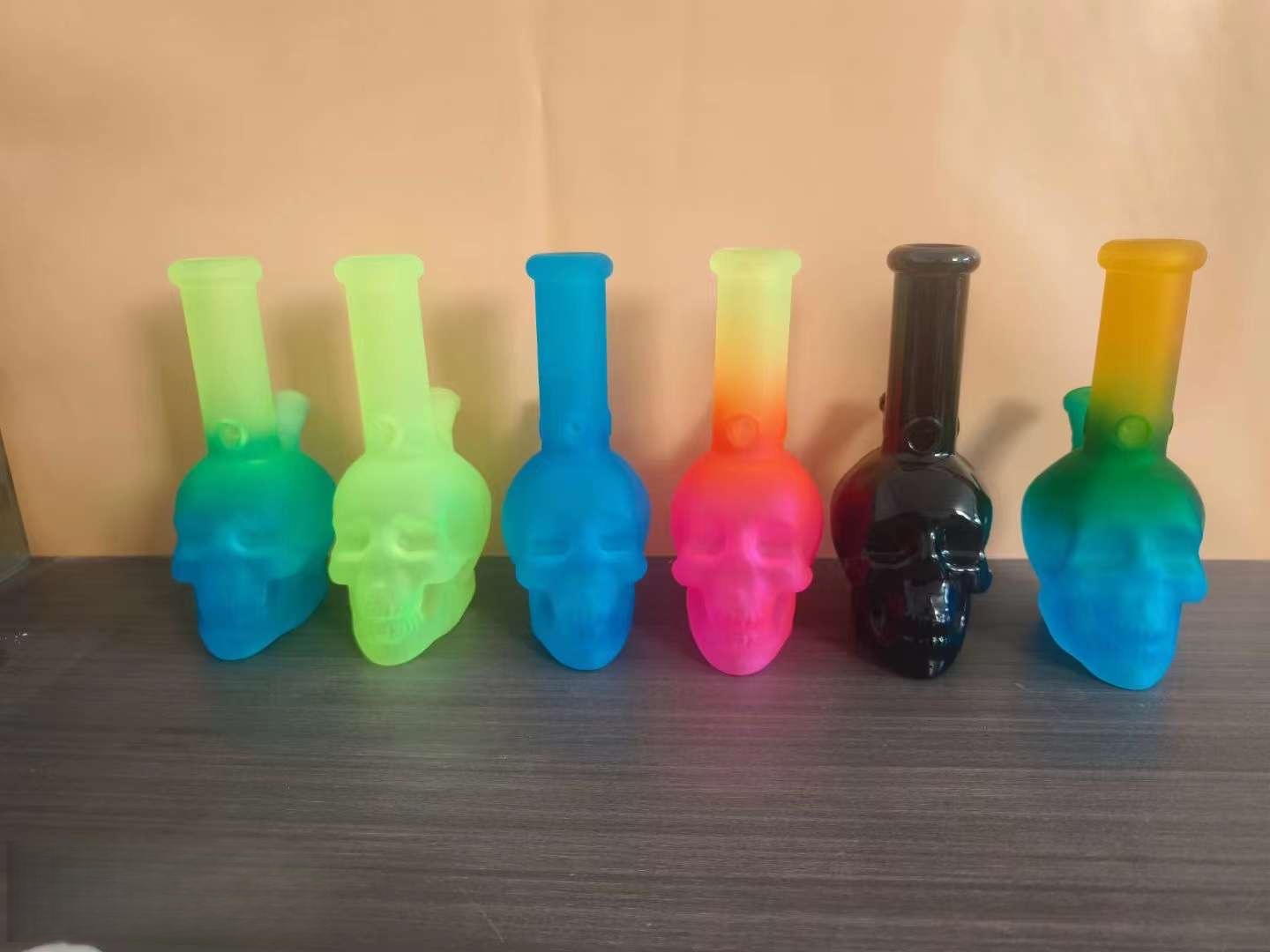Colorful small glass bongs arranged for smoke shop shelf display